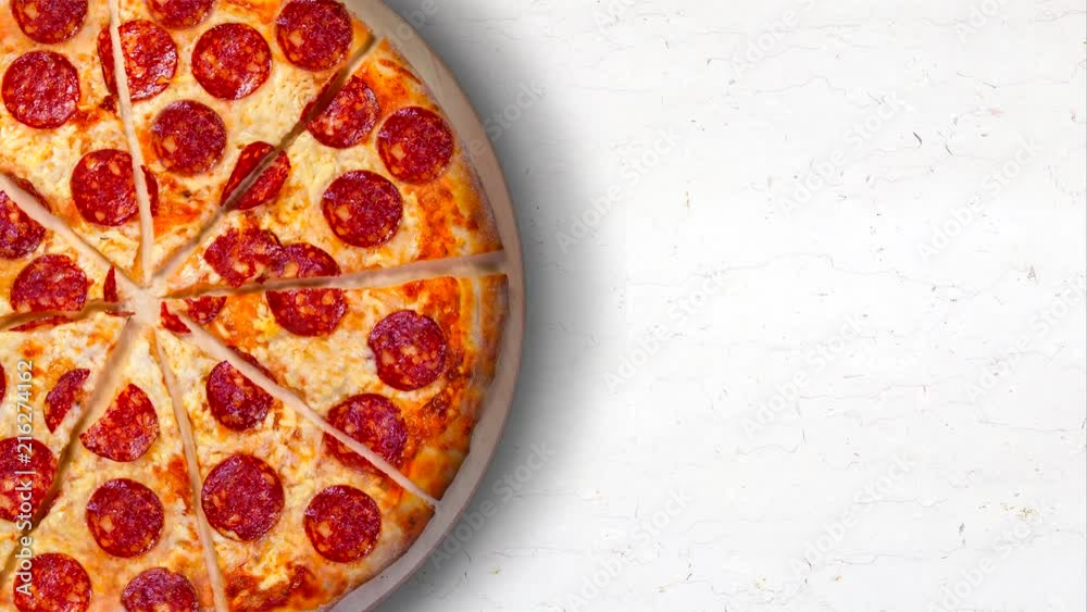 Video pepperoni pizza on a white marble kitchen table. 