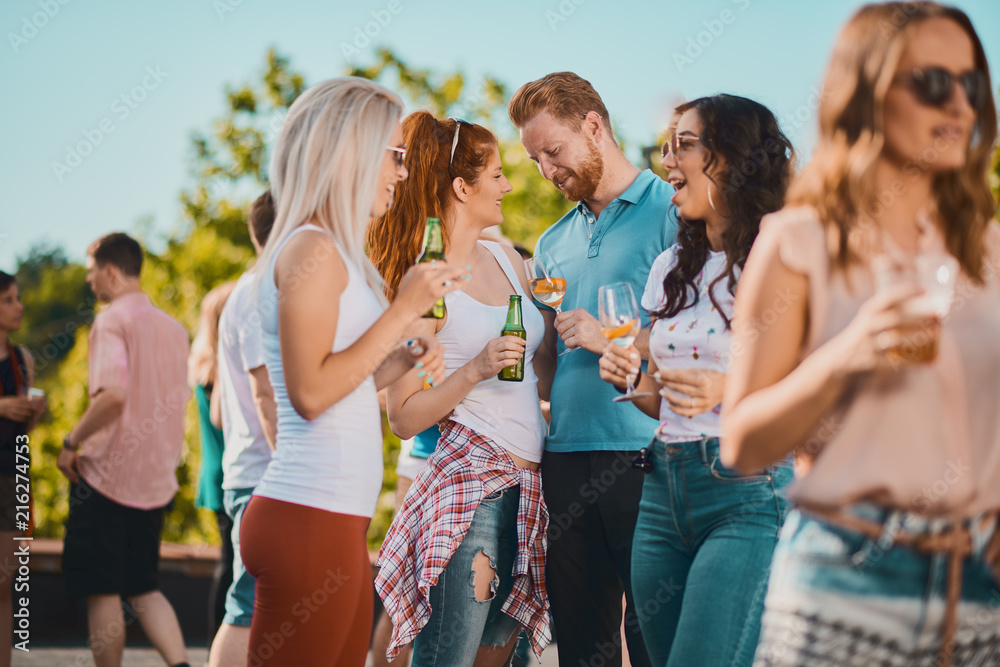 Group of people dancing and having a good time at the outdoor party/music festival 