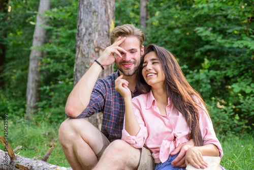 Couple spend time outdoors on sunny day. Youth on picnic or hike relaxing and having fun. Pleasant weekend. Couple tourists rest forest. Couple or family having great time relaxing with book