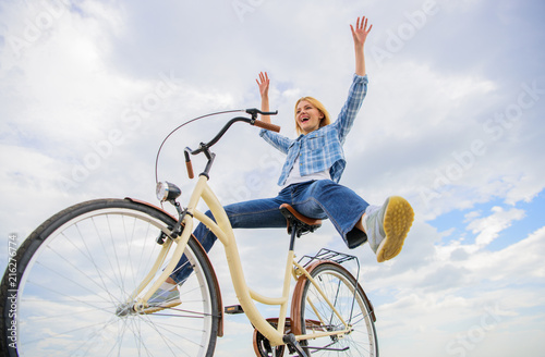 Pedaling towards happiness. Woman feels happy while enjoy cycling. Girl rides bicycle sky background. How cycling changes your life and make you happy. Reasons to ride bicycle. Mental health benefits