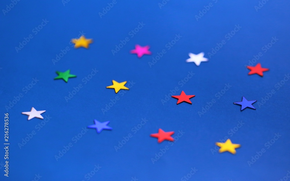 Flat lay of star decorations closeup on blue texture blur background