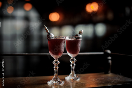 Two red delicious cocktails on the bar counter