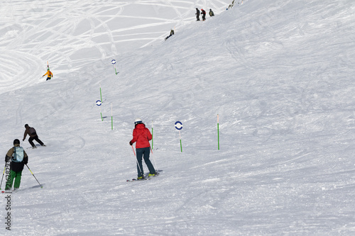 Skiers and snowboarders downhill