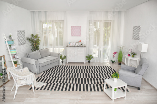 Modern living room design with big striped carpet © Africa Studio
