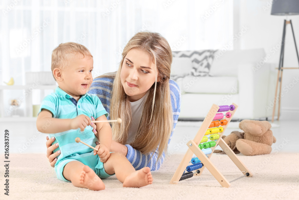 Baby and mother playing with toy abacus at home Baby and mother playing with toy abacus at home