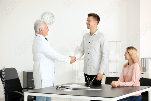 Male doctor consulting youn...