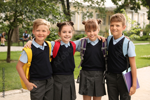 Little children in stylish school uniform outdoors