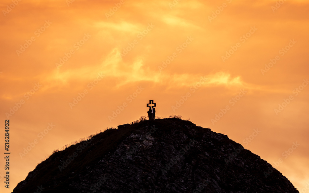 people on mountain summit peak with cross during sunset silhouette dramatic sunset brienzer rothorn switzerland