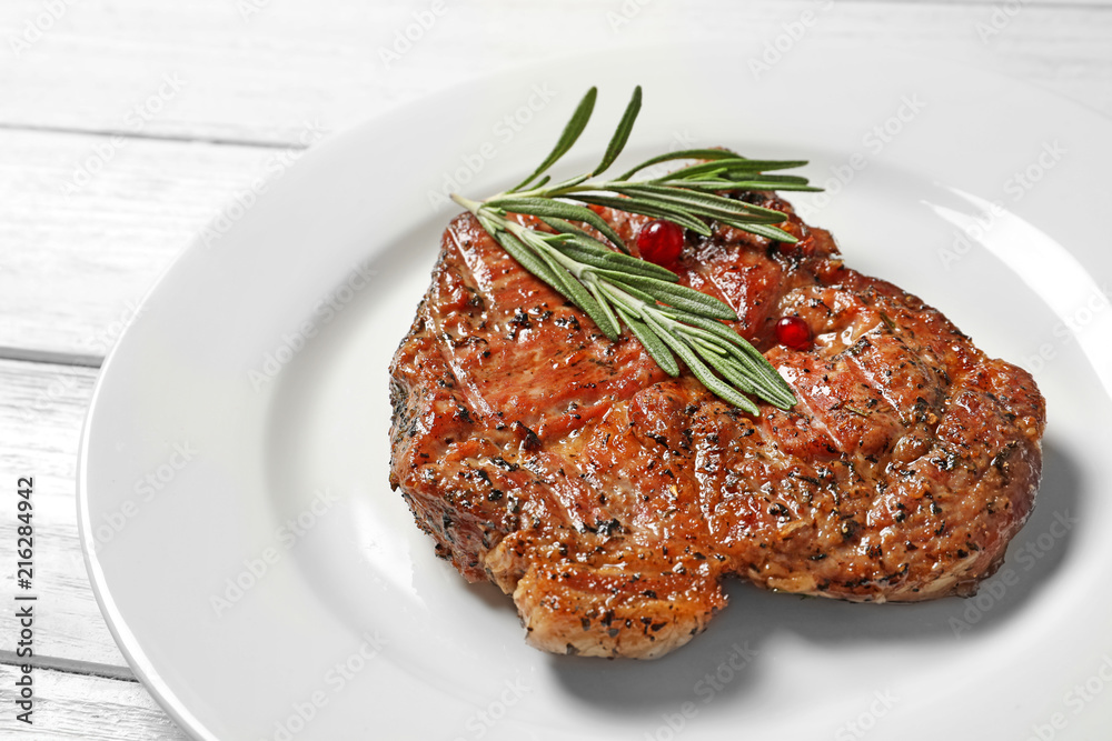 Plate with tasty grilled meat on table, closeup Plate with tasty grilled meat on table, closeup