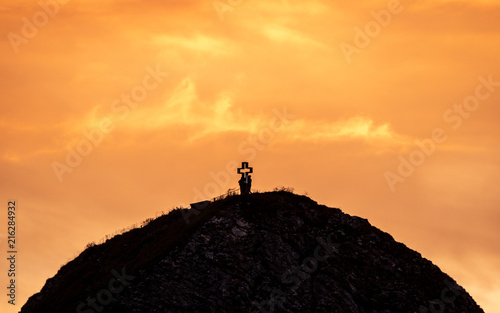 people on mountain summit peak with cross during sunset silhouette dramatic sunset brienzer rothorn switzerland