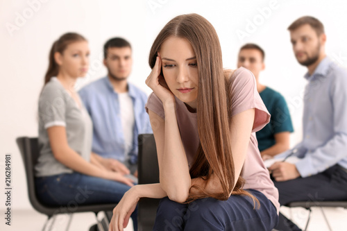 Sad young woman at group th...