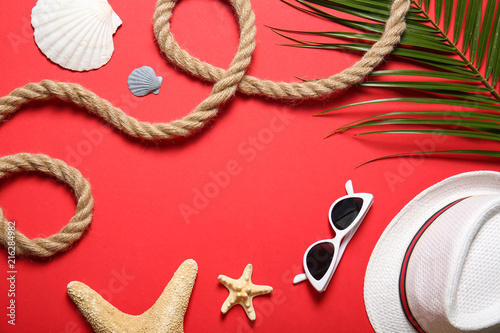 Flat lay composition with rope and beach objects on color background