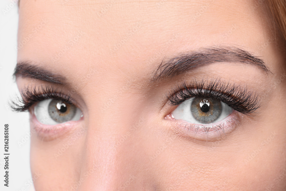 Fototapeta premium Beautiful young woman with eyelash extensions, closeup