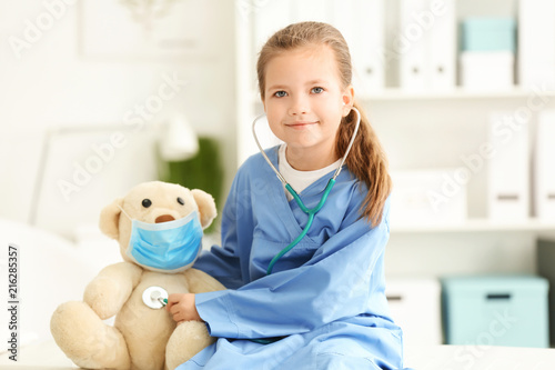 Cute little girl in doctor ...