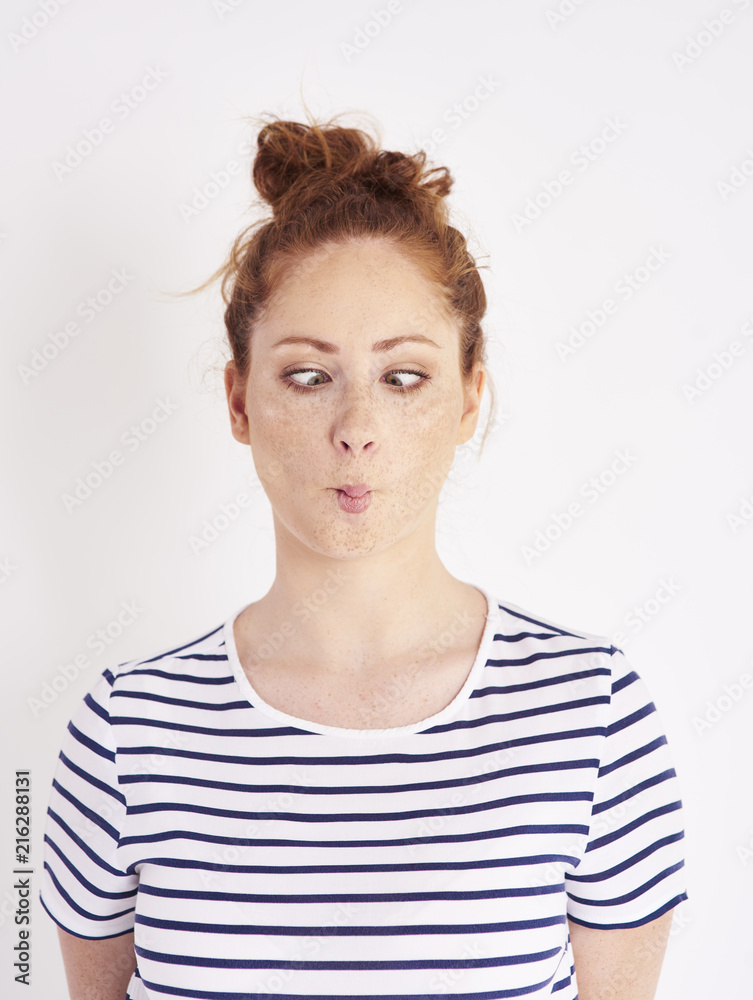 Cross eyed woman making a face at studio shot Cross eyed woman making a face at studio shot
