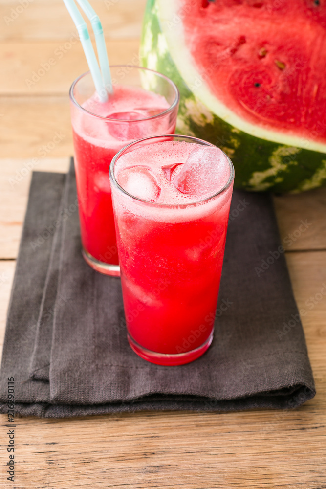 Watermelon smoothies on a black napkin and wooden background, cocktail, cold drink Watermelon smoothies on a black napkin and wooden background, cocktail, cold drink