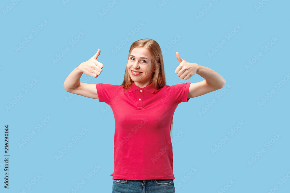 The happy business woman standing and smiling against blue background.