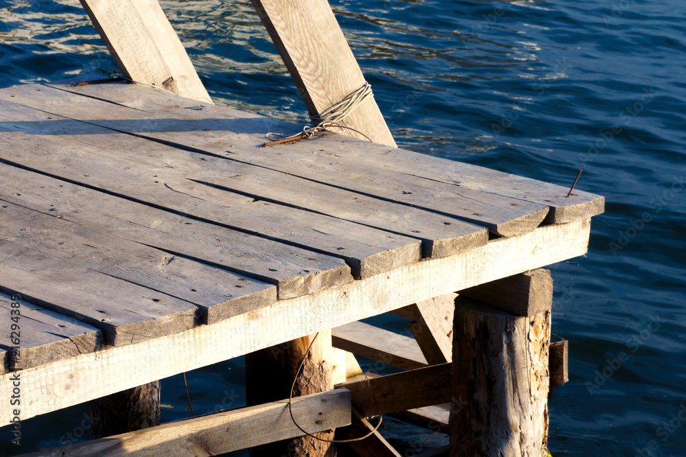 wooden staircase in the wate leading to the water blue wooden staircase in the wate leading to the water blue