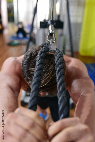 Muscular Man exercising in gymnasium with the rope