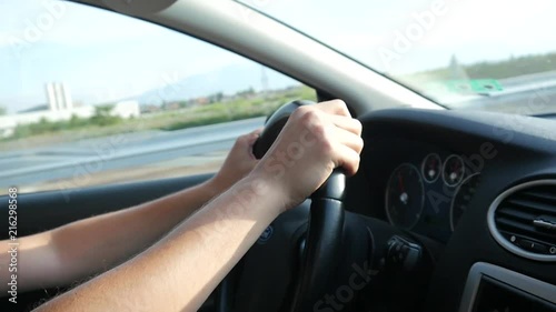 Wallpaper Mural Man drives the car holding hands on the steering wheel on autobahn highway Torontodigital.ca