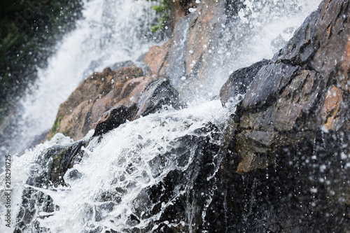 Cropped waterfall, water drops and stones