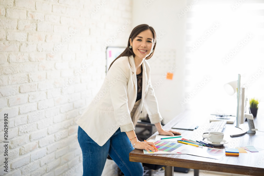 Happy female designer at work