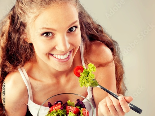 Attractive caucasian smiling woman with salad