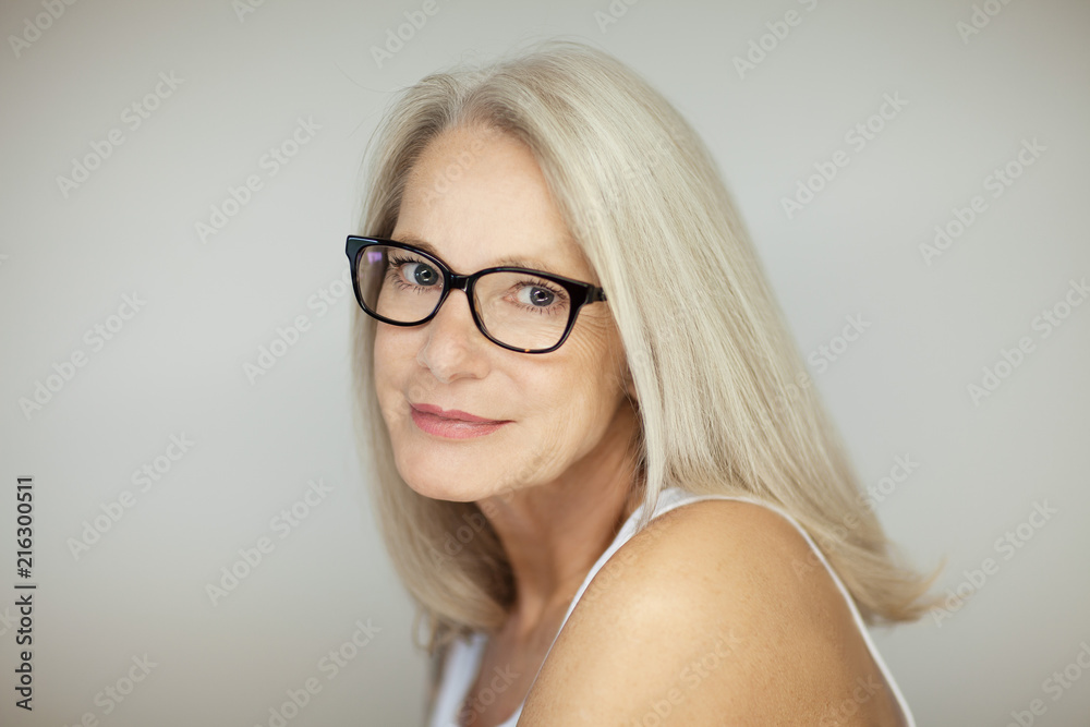 stunning beautiful and self confident best aged woman with grey hair smiling into camera, portrait with white background stunning beautiful and self confident best aged woman with grey hair smiling into camera, portrait with white background