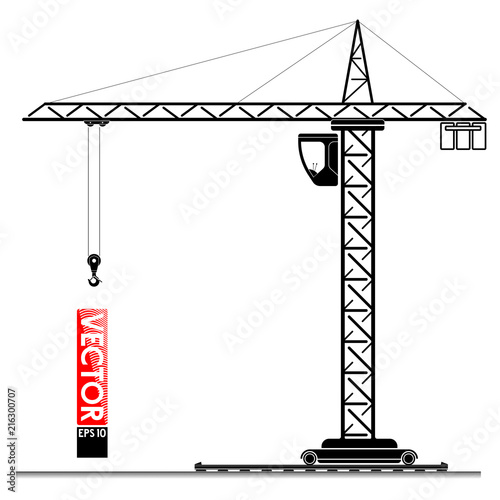 High tower crane at the construction site. Lifting loads up. The building of a high-rise building.