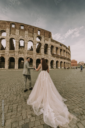 Young wedding couple by the Colosseum in Rome, Italy