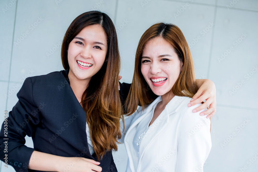 two asian businesswoman friends smile with happiness and joyful in office background two asian businesswoman friends smile with happiness and joyful in office background