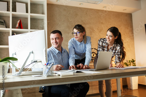 Wallpaper Mural Group of office  workers using computer and discuss about business project.Teamwork concept. Torontodigital.ca