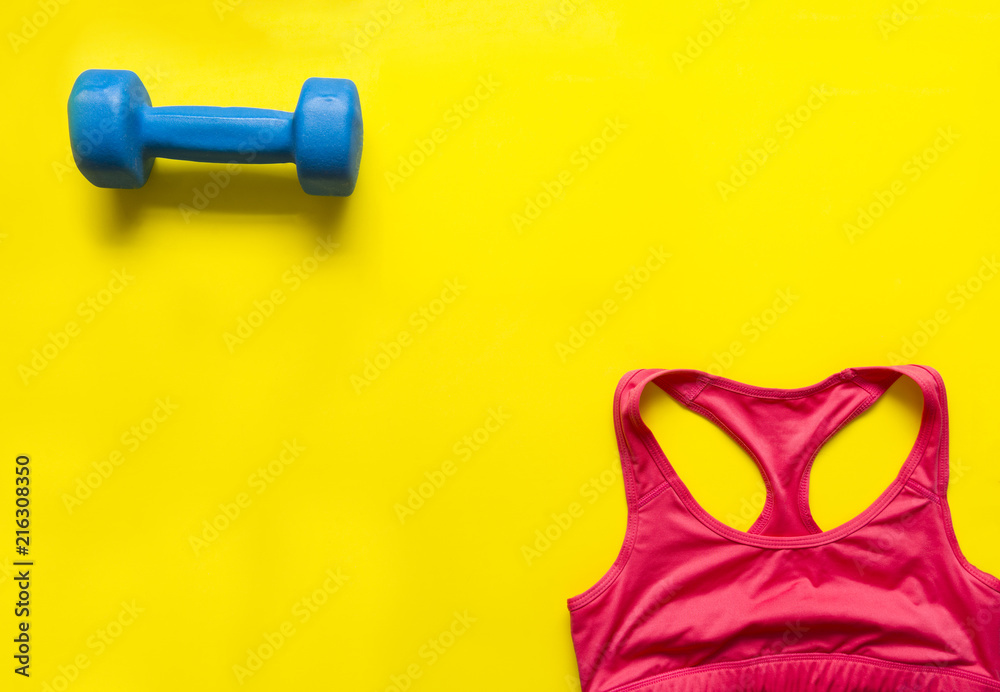 dumbbell and red sports tank top on yellow background, sportswear top view, dumbbell and red sports tank top on yellow background, sportswear top view,