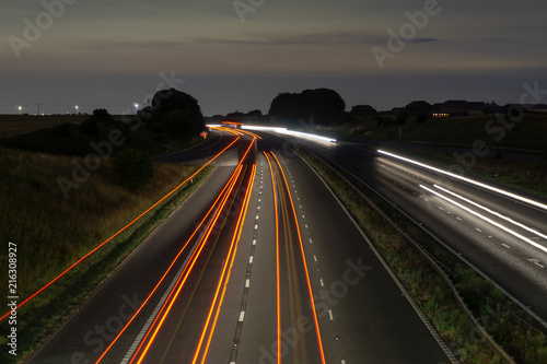 Motorway at night with streaming lights from cars