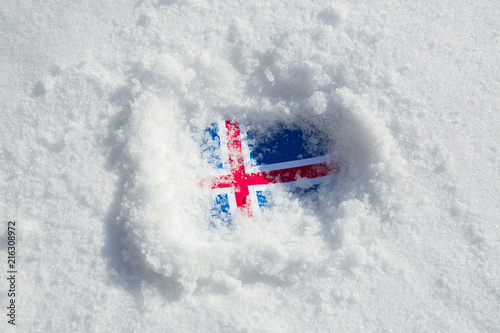 Flag of Iceland covered with snow and ice. 
