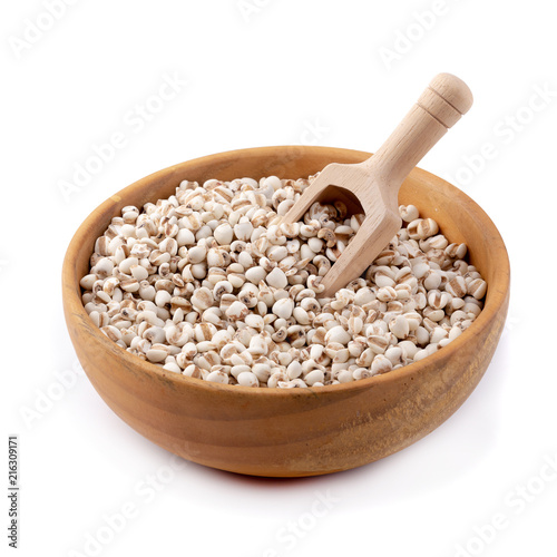 Millet rice in a wooden bowl isolated on white background