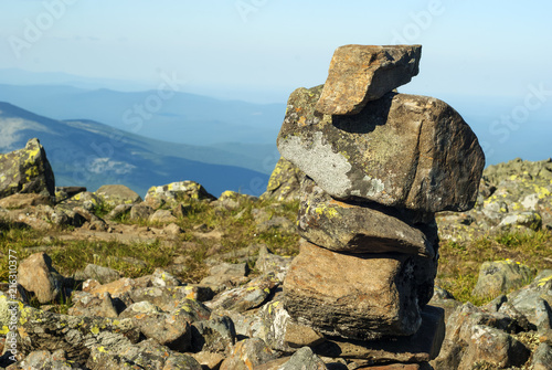 stone pyramid - a road sign on the mountain pass, reminiscent of a primitive sculpture.. photo