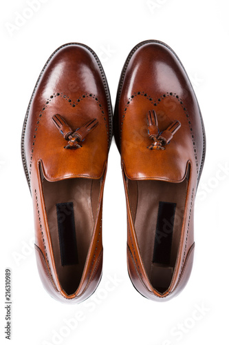 brown leather men's shoes of classic style, a pair of shoes with tassels on white background, isolate, top view