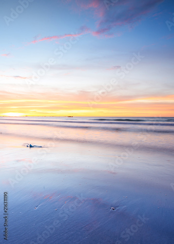 Beautiful and romantic sunset colour at the beach with reflection. suitable for background. 