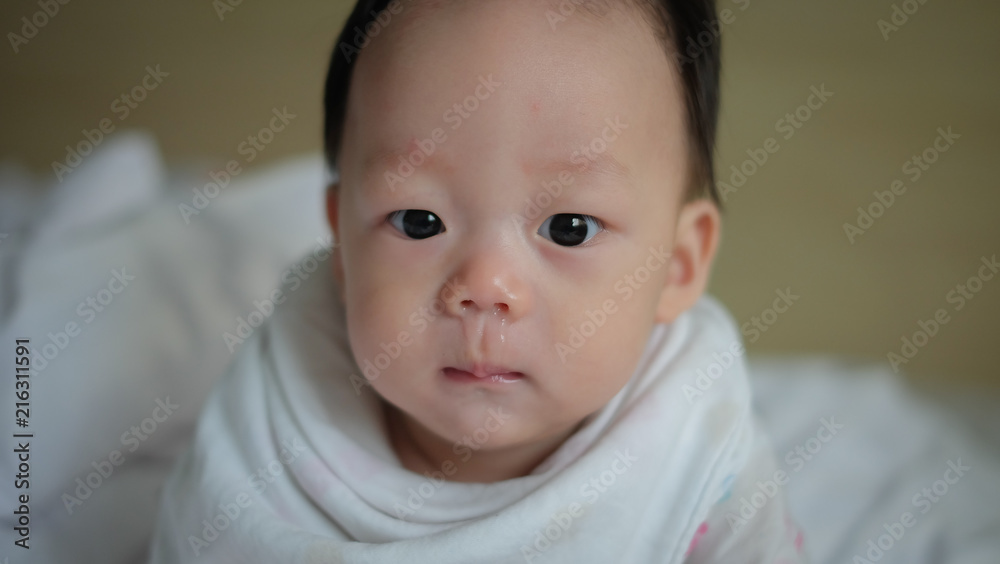 The Asian boy have a cold with snot. The Asian boy have a cold with snot.