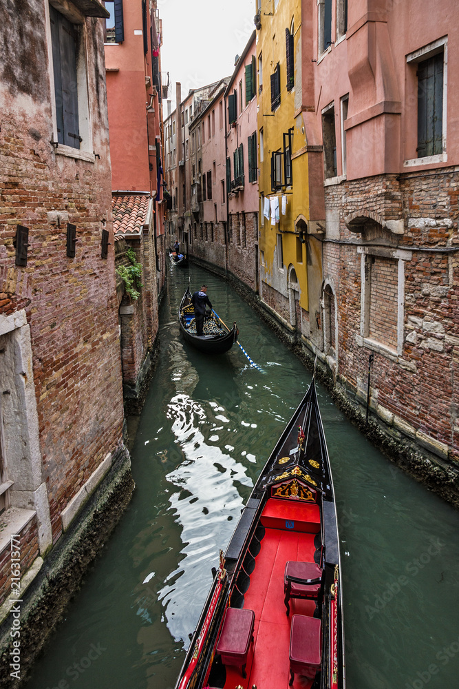 Venice, Italy. Gondolas in canal, narrow street