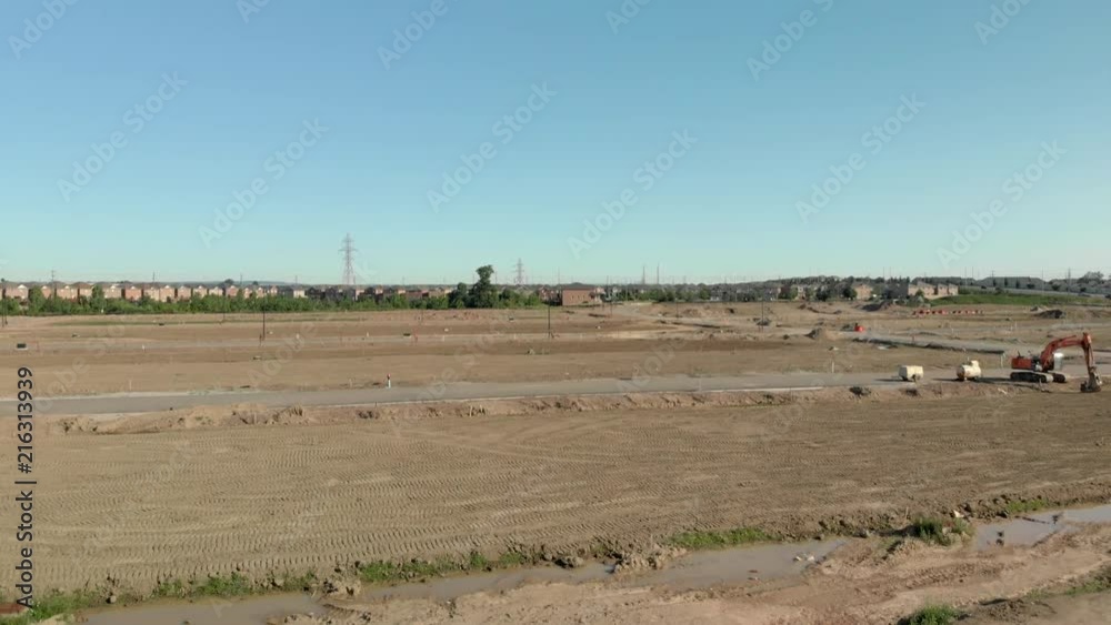 Reveal shot of future housing development in suburban area in Ontario, Canada. Site Preparation. Reveal shot of future housing development in suburban area in Ontario, Canada. Site Preparation.