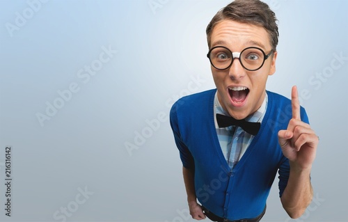 Young nerd man posing on background photo