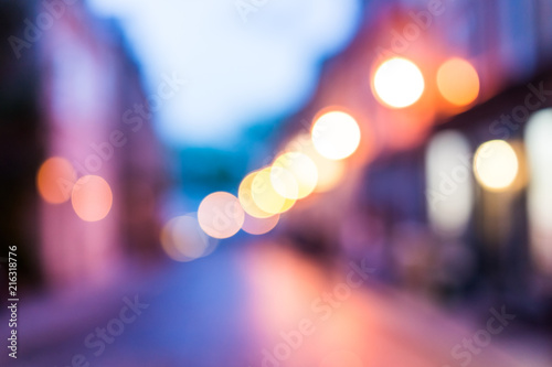 Abstract bokeh background of European street at twilight purple evening