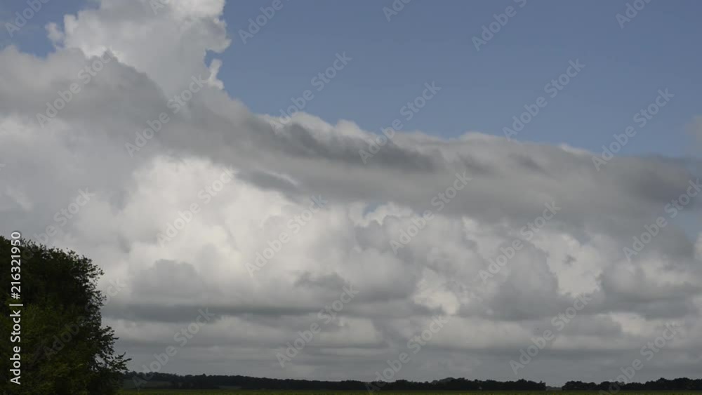 huge clouds over an agricultural field, a sunny summer day. huge clouds over an agricultural field, a sunny summer day.