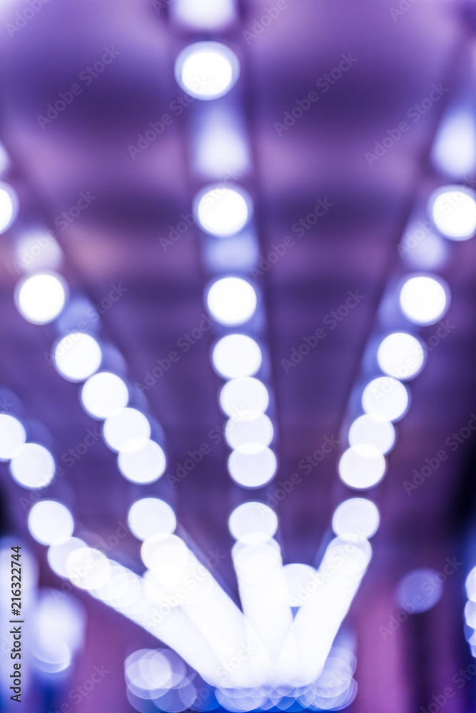Abstract bokeh background of blue lights in alley passage leading to exit