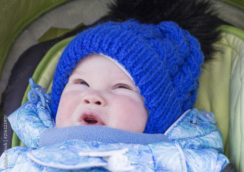 Child in a baby carriage in cold weather Child in a baby carriage in cold weather