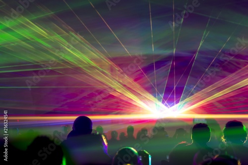 Hyper laser show. Very colorful show with a crowd silhouette and great laser rays at youth party festival