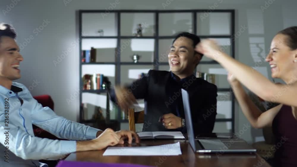 Happy Multiracial Business Team Meeting Celebrating Success in Casual Modern Office Boardroom