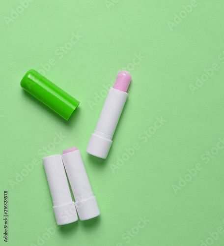 Hygienic lipstick on a blue pastel background, top view, minimalism. photo